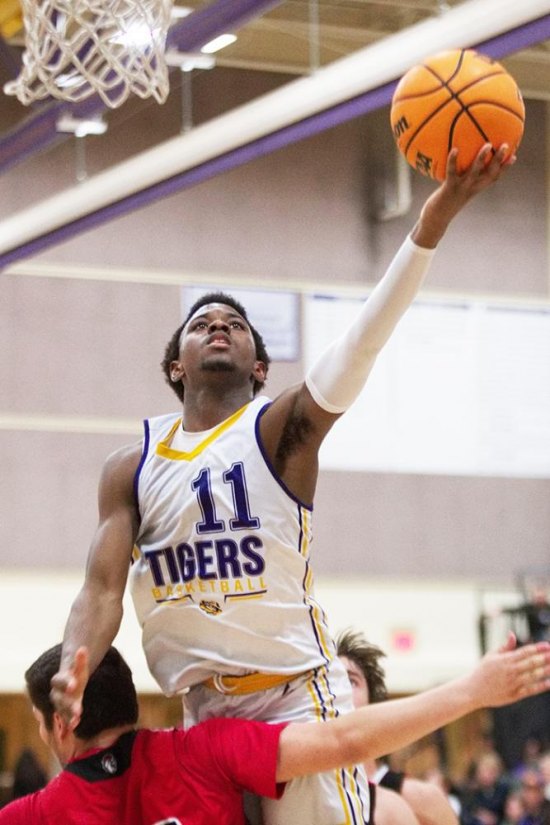 Lemoore's DeMel  Turner goes high to score in the West Yosemite League finale against visiting Hanford. 